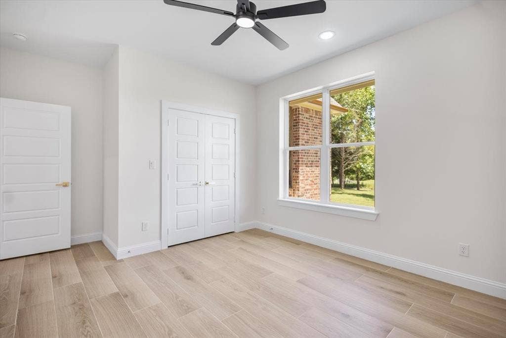 13920 Cedar Hill, Tyler, TX 75704 Wood-finish flooring, white paneled doors, recessed lighting, and a modern ceiling fan