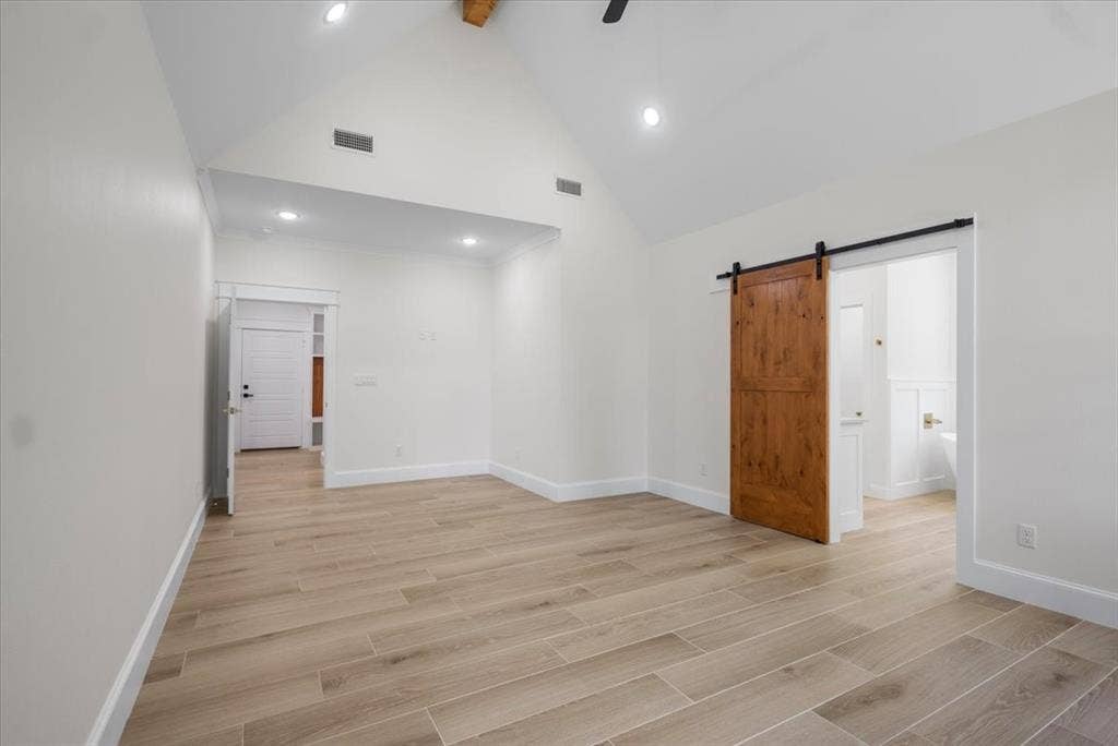 13920 Cedar Hill, Tyler, TX 75704 Vaulted ceiling with exposed wood beam, recessed lighting, wood-finish tile flooring, and a modern barn door