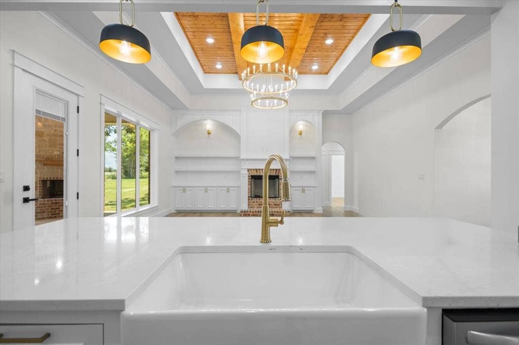 13920 Cedar Hill, Tyler, TX 75704 Spacious interior featuring a white farmhouse sink, white countertops, and a gold-finish faucet
