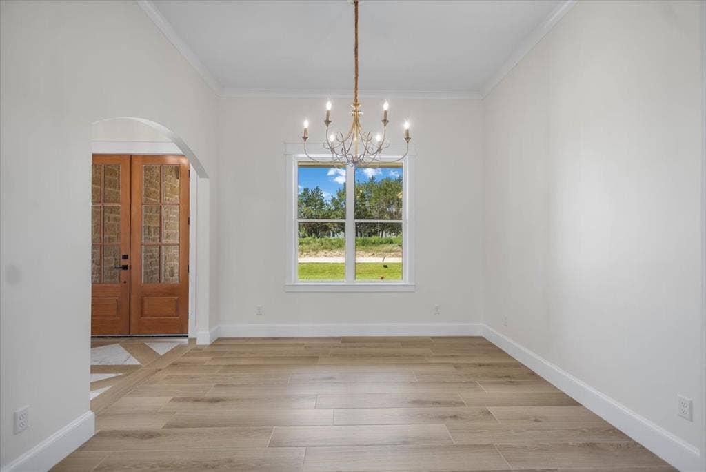 13920 Cedar Hill, Tyler, TX 75704 Wood-finish plank flooring, arched entryway, double pane windows, crown molding, and a chandelier