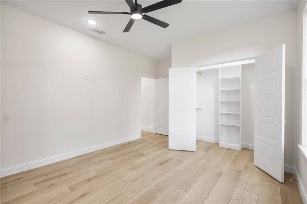 13920 Cedar Hill, Tyler, TX 75704 Wood-finish flooring, recessed lighting, ceiling fan, built-in shelving, and white panel doors