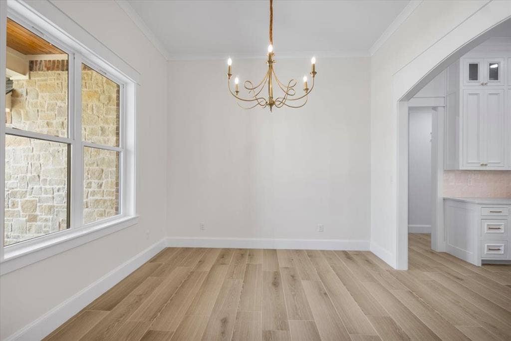 13920 Cedar Hill, Tyler, TX 75704 Wood-finish flooring, white trim work, white walls, and a decorative chandelier