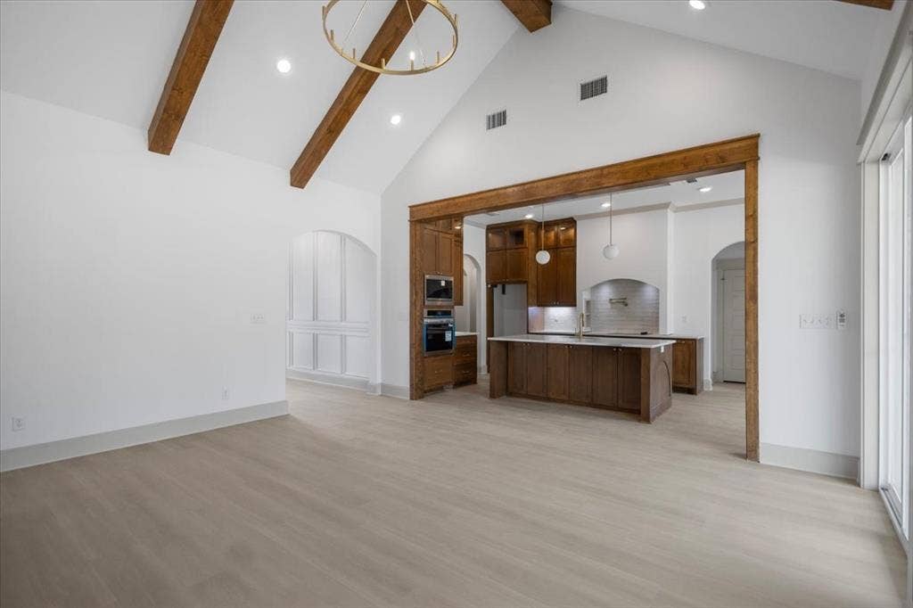 17155 Island Lake Dr., Tyler, TX 75708 Vaulted ceiling with exposed wood beams, wood-finish flooring, recessed lighting, and a modern chandelier