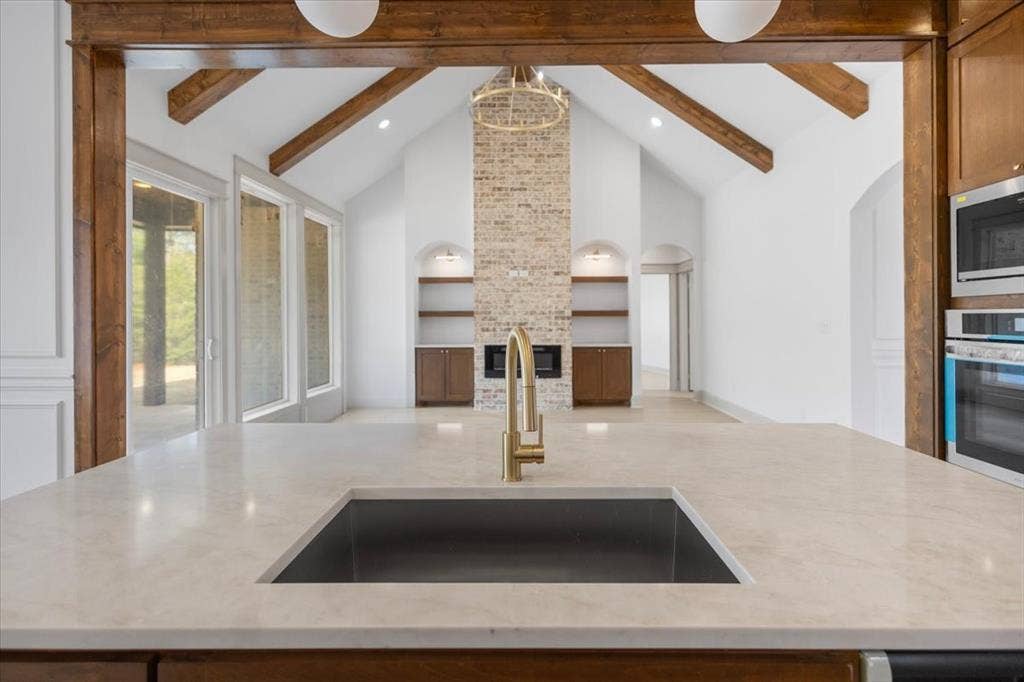 17155 Island Lake Dr., Tyler, TX 75708 Kitchen island featuring a built-in sink with a gold-finish faucet