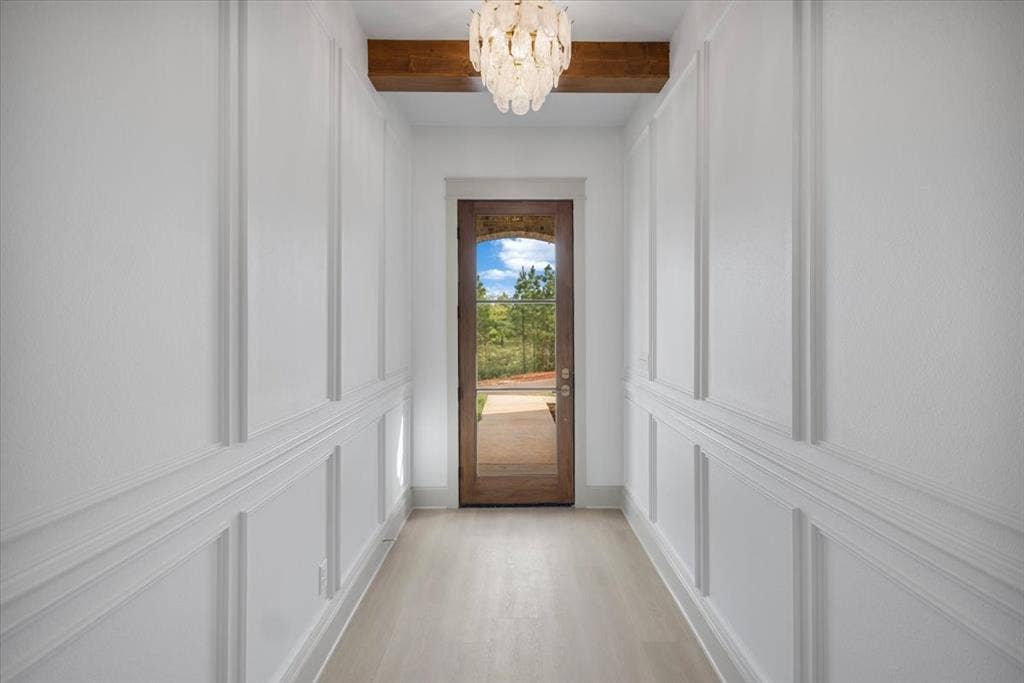 17155 Island Lake Dr., Tyler, TX 75708 Hallway with decorative wainscoting, wood-finish flooring, exposed wood beam, and a glass-paneled entry door