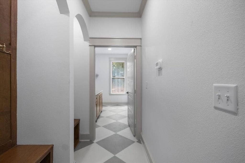 17155 Island Lake Dr., Tyler, TX 75708 Hallway with arched entryway, built-in wooden bench, and diamond-patterned flooring