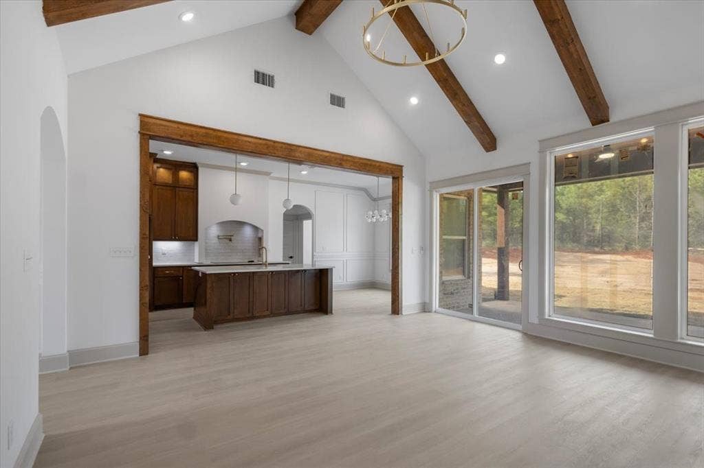 17155 Island Lake Dr., Tyler, TX 75708 Vaulted ceiling with exposed wood beams, wood-finish flooring, recessed lighting, and a large sliding glass door