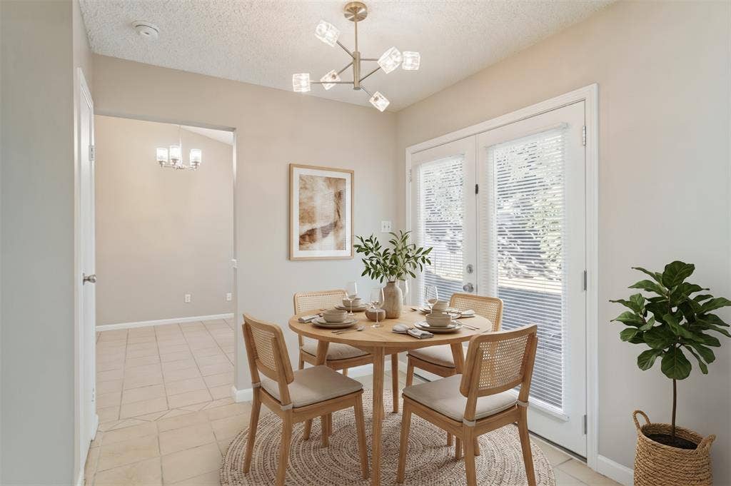 204 Timber Ridge Lane, Coppell, TX 75019 Vaulted ceiling featuring a modern chandelier, double French doors, and tile flooring