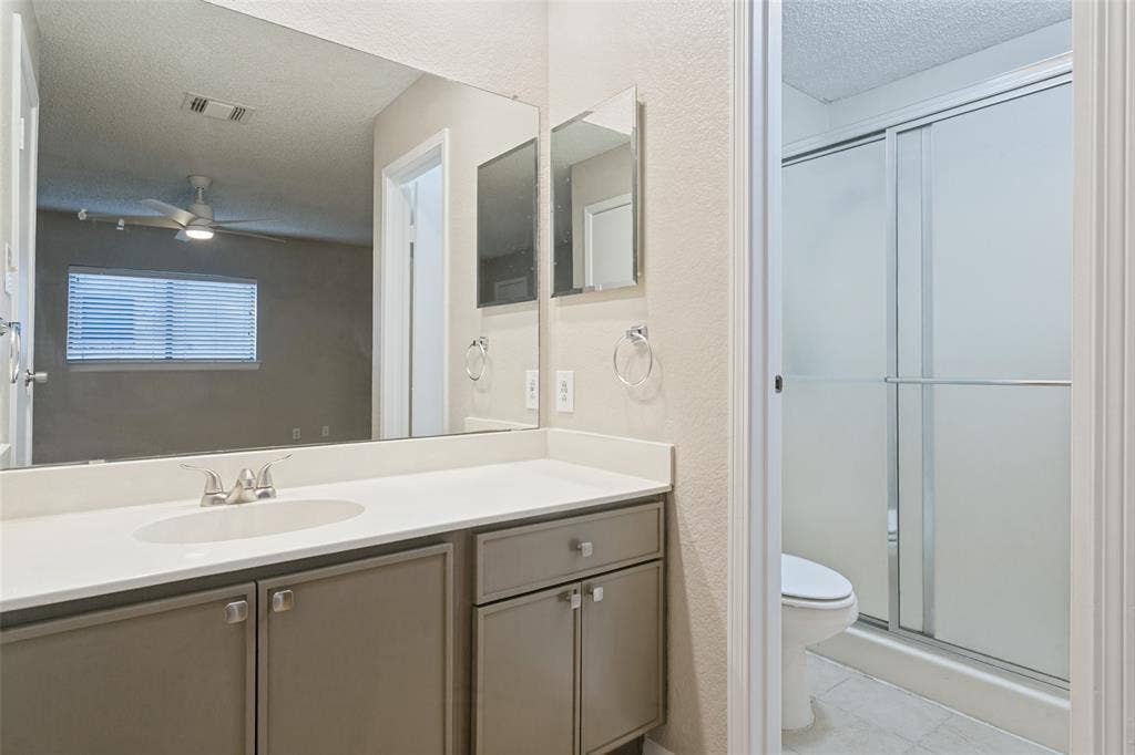 204 Timber Ridge Lane, Coppell, TX 75019 Vanity with a single basin sink, light-toned countertop, and undermount cabinetry