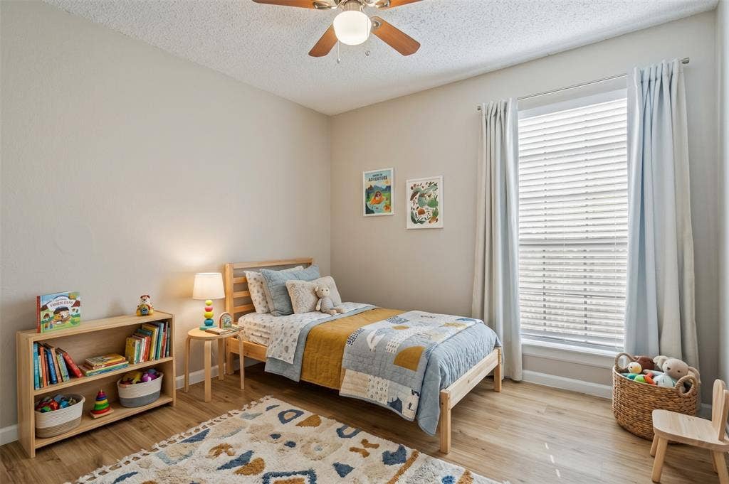 204 Timber Ridge Lane, Coppell, TX 75019 Wood-finish flooring, ceiling fan with integrated lighting, window with blinds, and light-toned wall paint