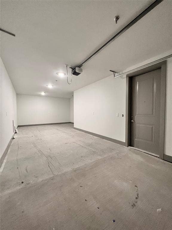 4020 McEwen Road, #9121, Farmers Branch, TX 75244 Garage featuring baseboards and a garage door opener