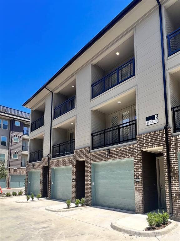 4020 McEwen Road, #9121, Farmers Branch, TX 75244 View of building exterior with driveway and an attached garage