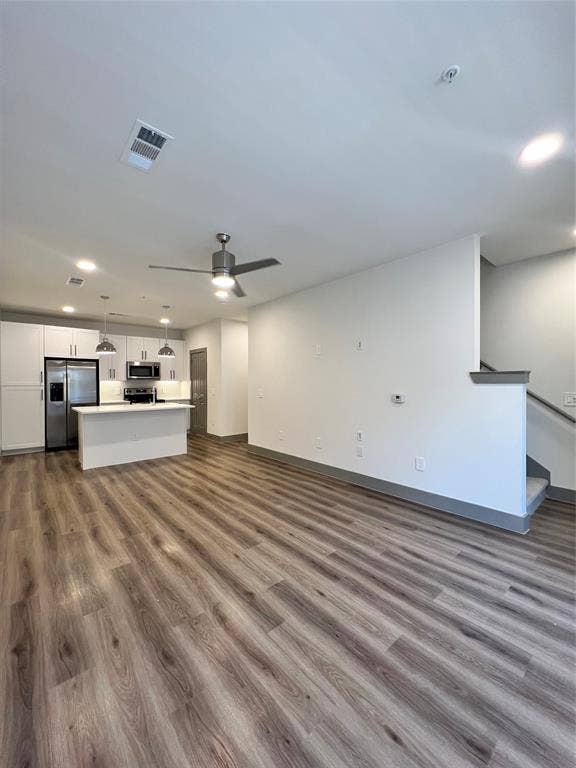 4020 McEwen Road, #9121, Farmers Branch, TX 75244 Unfurnished living room with dark wood finished floors, ceiling fan, and recessed lighting