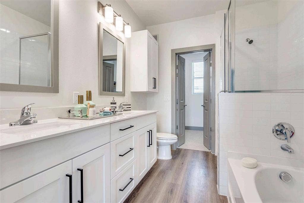 4020 McEwen Road, #9121, Farmers Branch, TX 75244 Bathroom with a bathtub, double vanity, light wood-style floors, and a tile shower
