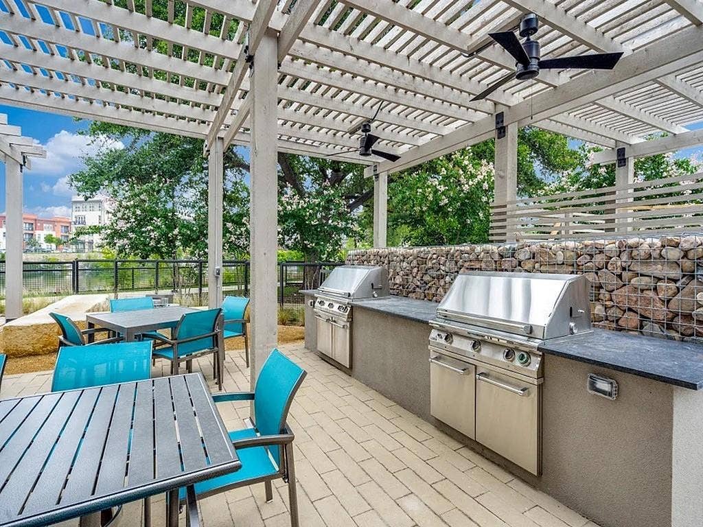 4020 McEwen Road, #9121, Farmers Branch, TX 75244 View of patio / terrace featuring a pergola, outdoor dining area, a ceiling fan, a water view, and area for grilling