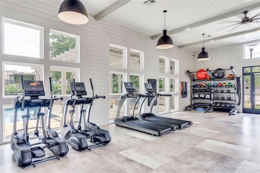 4020 McEwen Road, #9121, Farmers Branch, TX 75244 Workout area with beamed ceiling, a towering ceiling, french doors, wood walls, and ceiling fan
