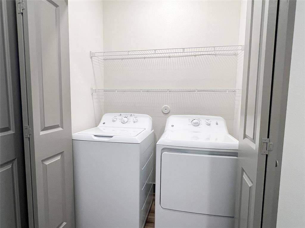 4020 McEwen Road, #8115, Farmers Branch, TX 75244 Laundry area with separate washer and dryer and wood finished floors