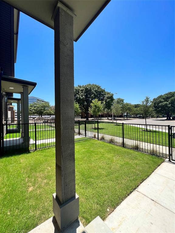 4020 McEwen Road, #8115, Farmers Branch, TX 75244 Landscaped front yard with a black metal fence and sidewalk access