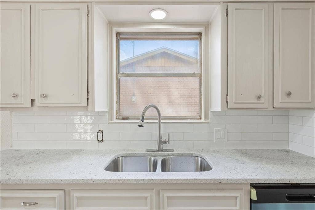 313 Carver Street, Waco, TX 76704 Clean up is a breeze with the new granite countertop and tile backsplash.