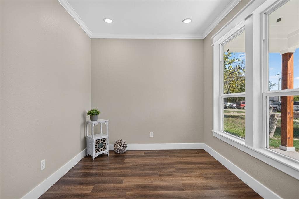 Office Room or fourth bedroom featuring wood-finish flooring, recessed lighting, crown molding, and large windows with heavy white trim