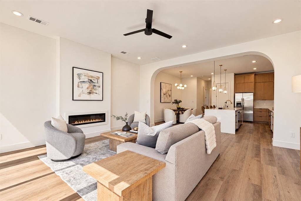 903 Bayonne Street, Dallas, TX 75212 Recessed lighting, wood-finish flooring, a modern linear fireplace, a ceiling fan, and an arched entryway