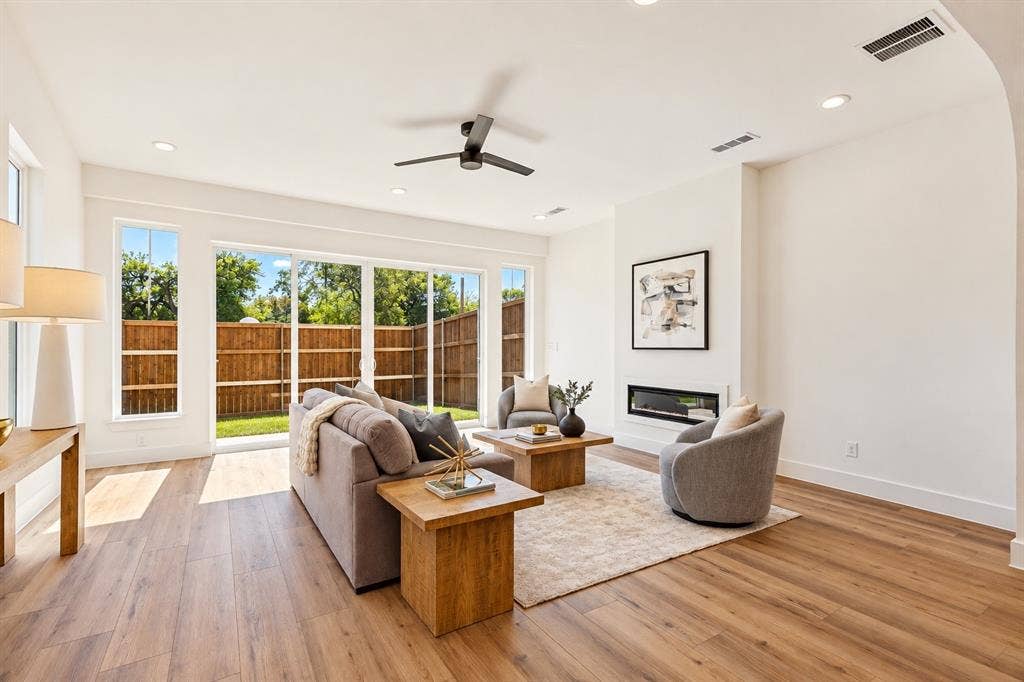 903 Bayonne Street, Dallas, TX 75212 Open-concept living space with wood-finish flooring, a contemporary fireplace, and recessed lighting