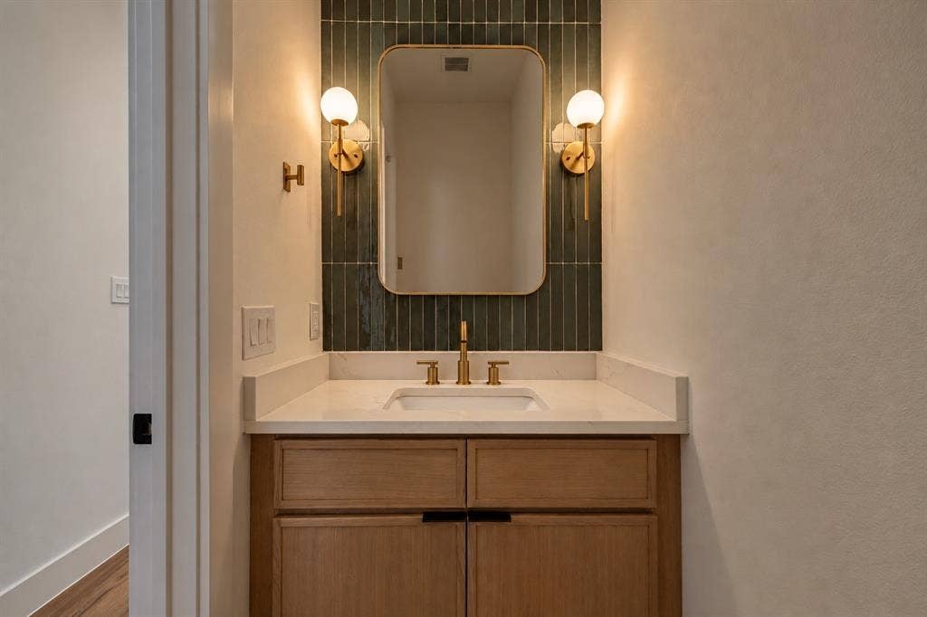 903 Bayonne Street, Dallas, TX 75212 Wood-finish vanity with an integrated sink and light-toned countertop