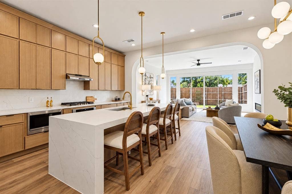 903 Bayonne Street, Dallas, TX 75212 Gourmet kitchen with light wood-finish cabinetry, white countertop surfaces, and stainless steel appliances