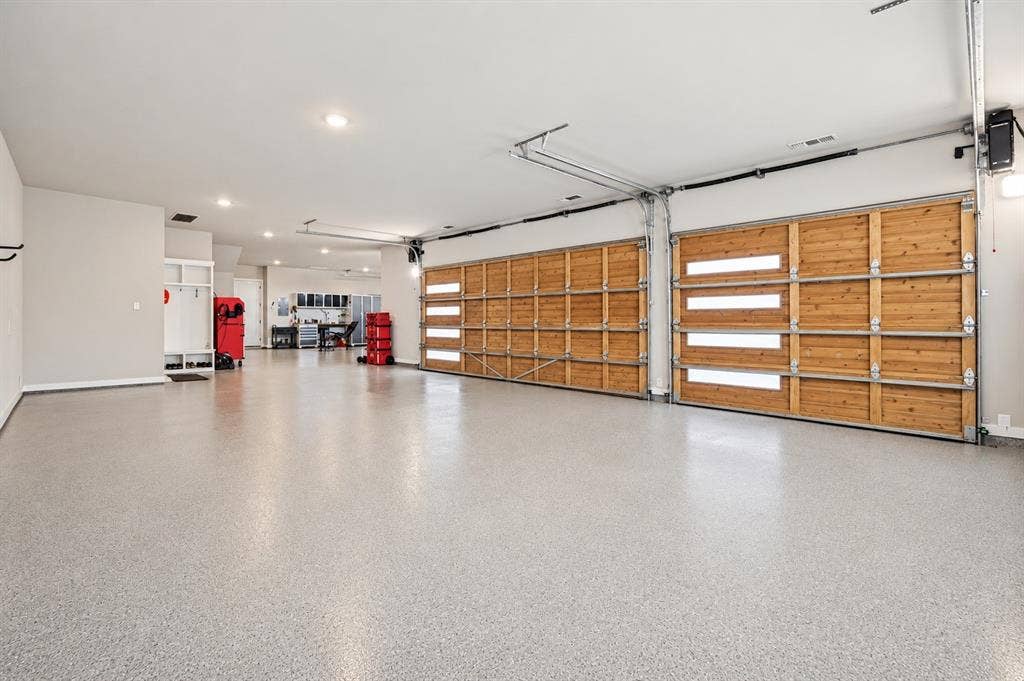 360 Crosswood Creek Court, Celina, TX 75009 Oversied and temperature controlled, epoxy flooring & attic lift to take all your items to the Texas basement storage area.