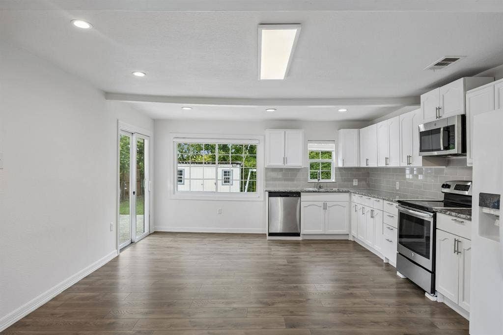 2245 County Road 337, McKinney, TX 75071 Kitchen featuring white cabinetry, stone-finish countertops, stainless steel appliances, wood-finish flooring, and recessed lighting