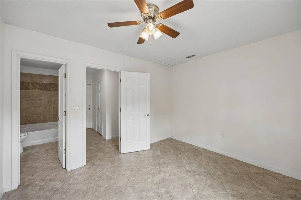 2245 County Road 337, McKinney, TX 75071 Neutral-tone tile flooring, six-panel interior doors, and a ceiling fan with integrated multi-bulb lighting