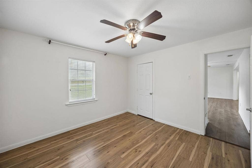 2245 County Road 337, McKinney, TX 75071 Interior space featuring wood-finish flooring, a multi-blade ceiling fan with integrated lighting, and a window with horizontal blinds