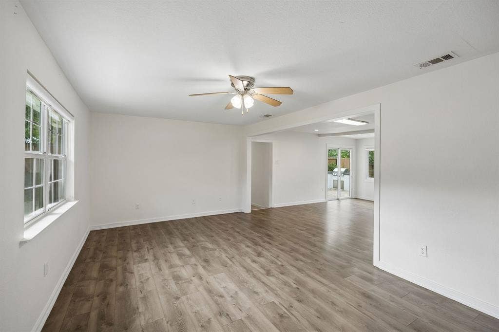 2245 County Road 337, McKinney, TX 75071 Wood-finish flooring, neutral walls, multi-pane window, and ceiling fan with integrated lighting