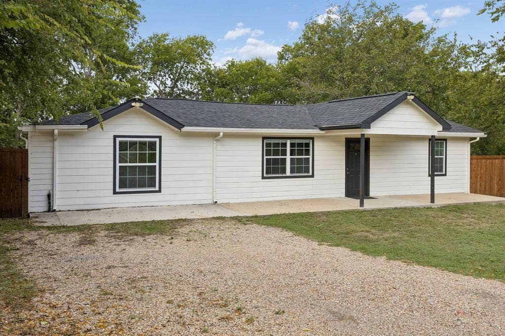 2245 County Road 337, McKinney, TX 75071 Single-story exterior featuring horizontal siding, a covered front porch, dark-trimmed windows, a multi-gable roofline, and a gravel driveway