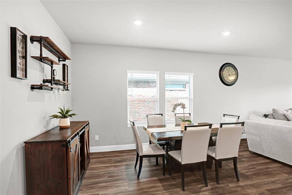 Dining space featuring dark wood-style floors and recessed lighting