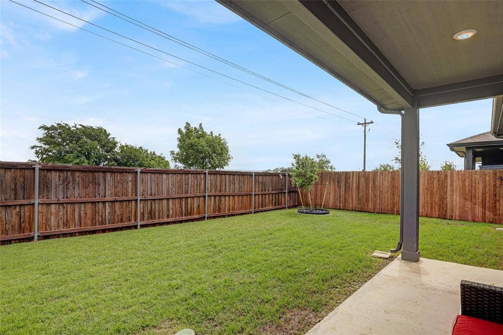 Fenced backyard with a patio area