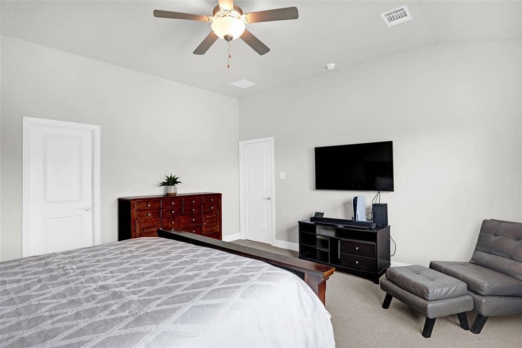 Bedroom with a ceiling fan and lofted ceiling