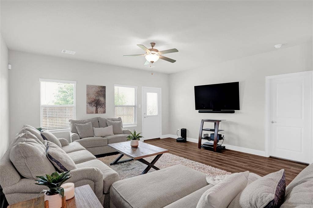 Living room featuring wood finished floors and a ceiling fan