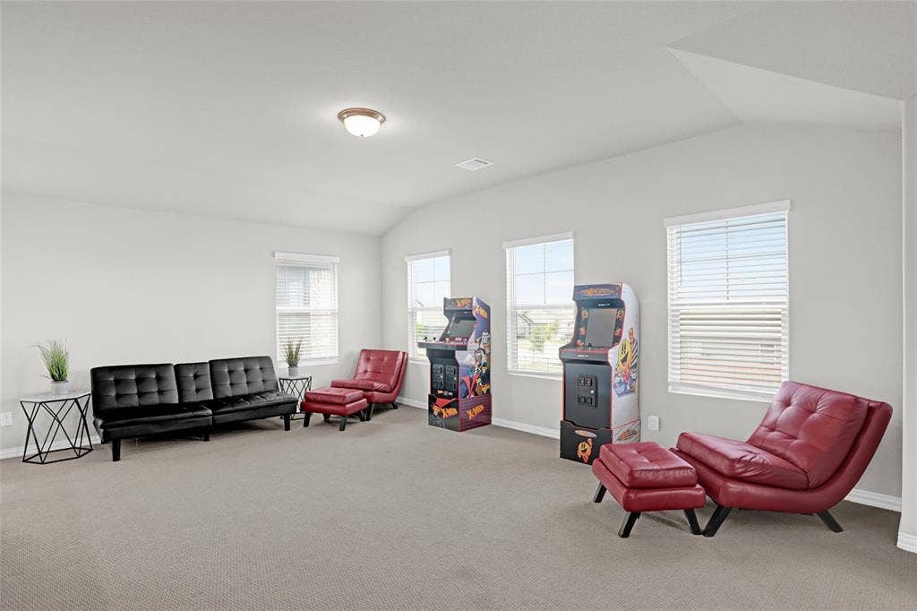 Living area with lofted ceiling and carpet