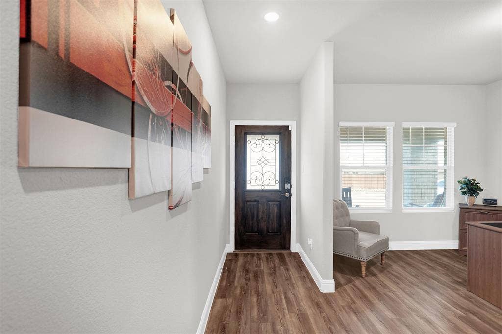 Foyer entrance featuring dark wood-style floors and recessed lighting