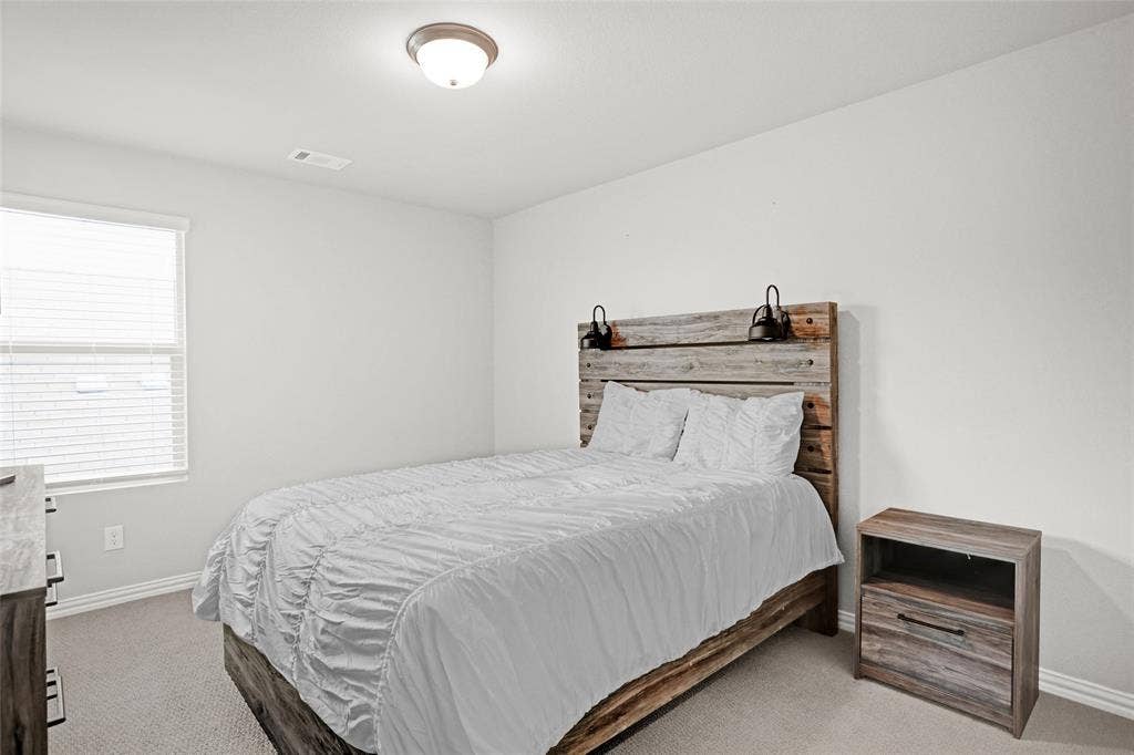Bedroom with carpet flooring and baseboards
