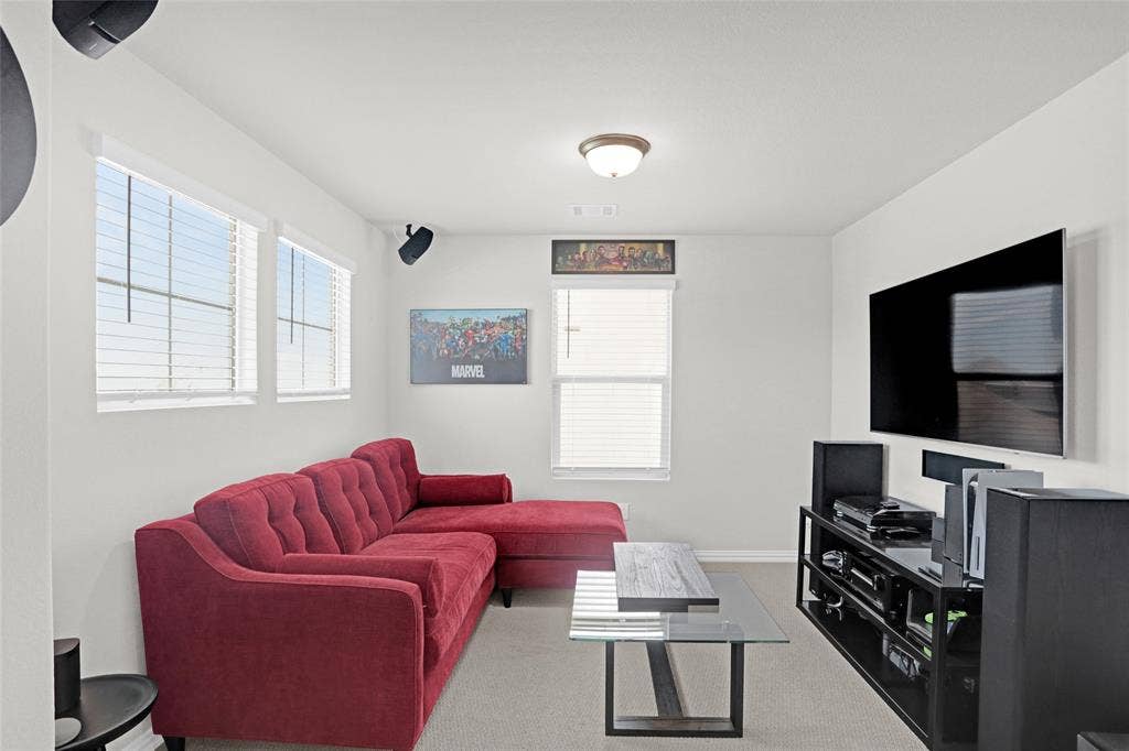 Carpeted living area with baseboards