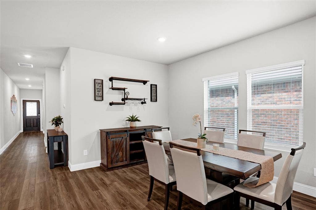 Dining area featuring dark wood finished floors and recessed lighting
