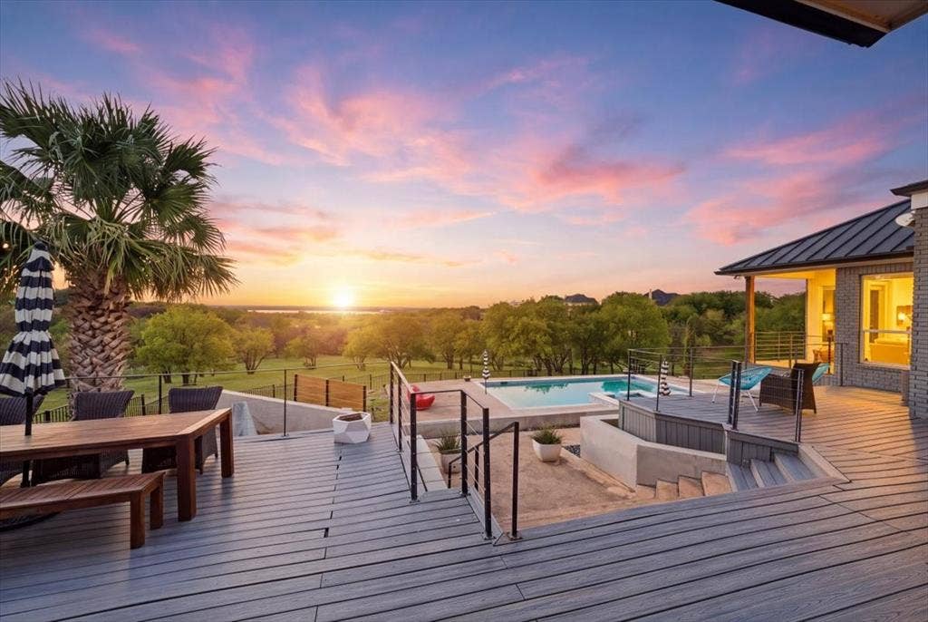 2945 Emerald Sound Drive, Cedar Hill, TX 75104 Multi-level deck with horizontal railing, built-in swimming pool, landscape backdrop, and metal roof overhang