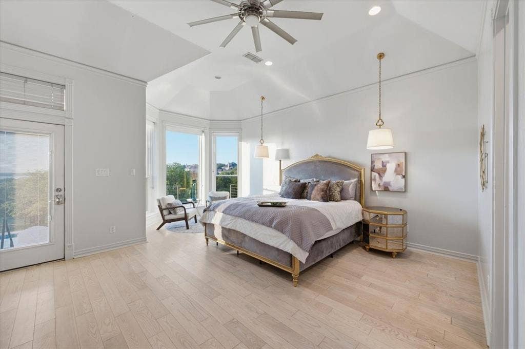 2945 Emerald Sound Drive, Cedar Hill, TX 75104 Tray ceiling featuring recessed lighting and a ceiling fan, light-toned wood-finish flooring, bay window architecture, and dual pendant light fixtures