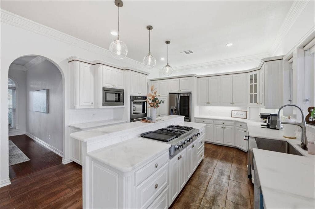 2945 Emerald Sound Drive, Cedar Hill, TX 75104 Kitchen featuring white cabinetry, wood-finish flooring, a central island with a cooktop, stone-surfaced countertops, and glass globe pendant lighting