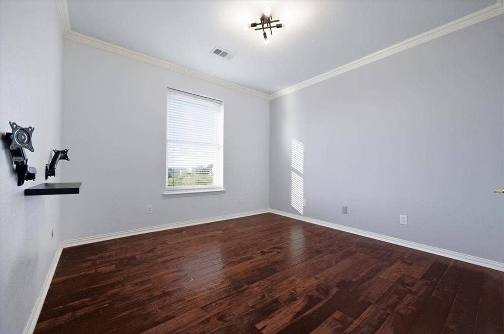 2945 Emerald Sound Drive, Cedar Hill, TX 75104 Room featuring dark wood-finish flooring, neutral wall tones, crown molding, and a central multi-light fixture