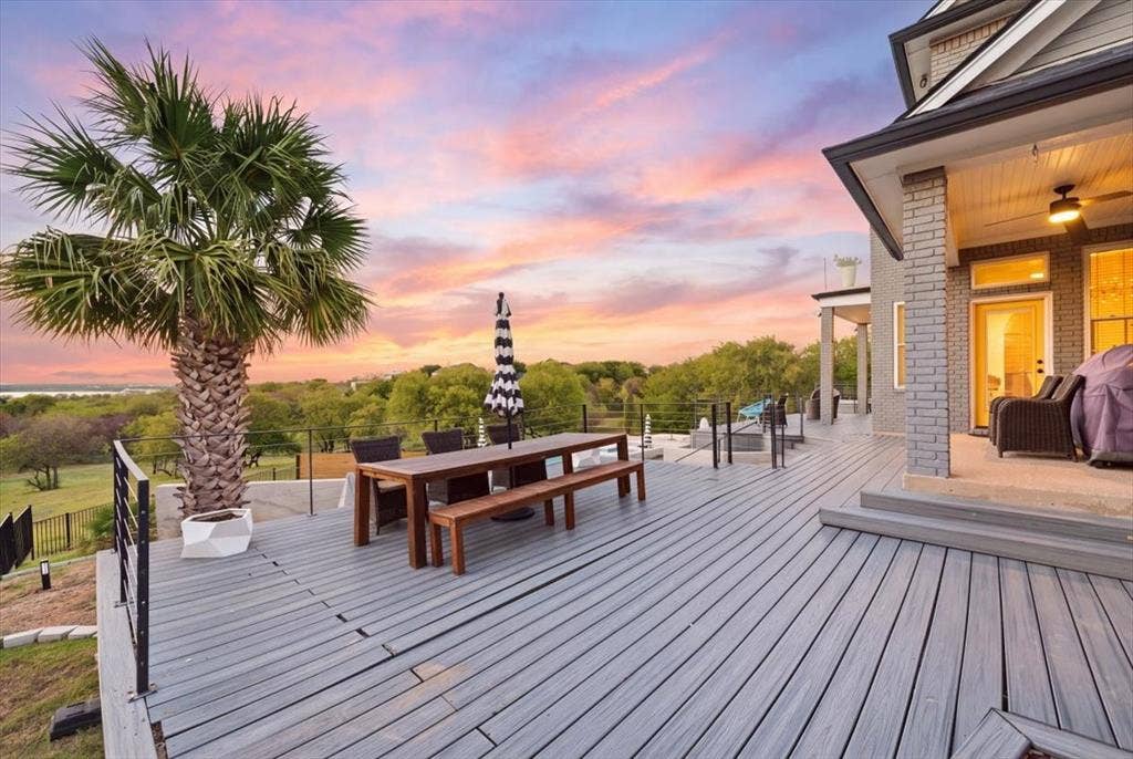 2945 Emerald Sound Drive, Cedar Hill, TX 75104 Multi-level composite deck featuring metal railing, integrated structural columns, covered porch area, and professional landscaping