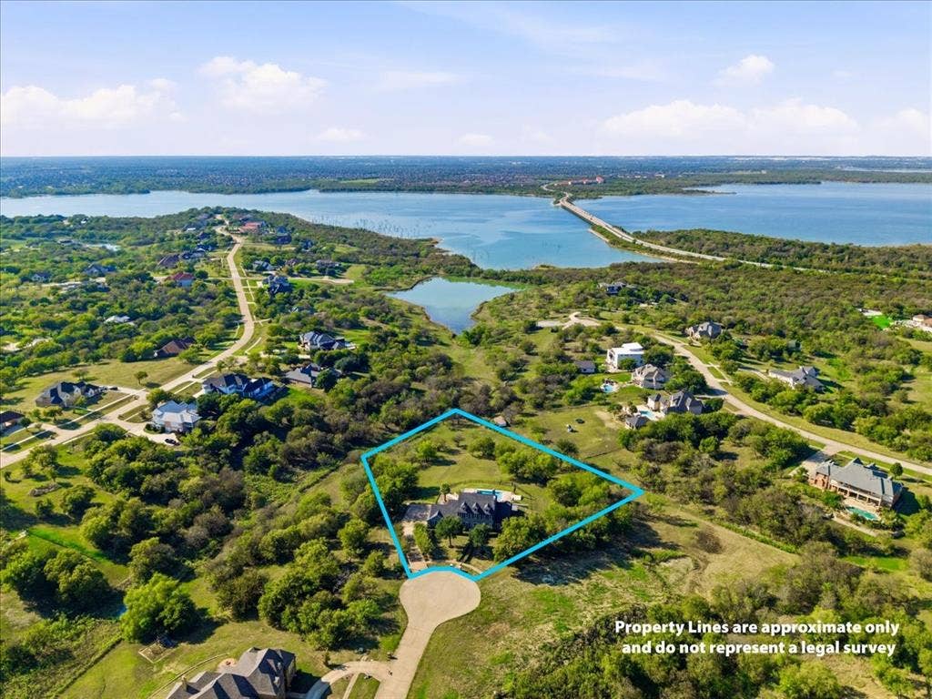 2945 Emerald Sound Drive, Cedar Hill, TX 75104 Aerial view of expansive residential lot featuring mature trees, a private swimming pool, and proximity to lakefront shoreline