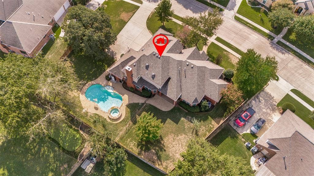 2704 Horsehead Crossing, Southlake, TX 76092 Aerial perspective of a multi-gabled residence featuring a swimming pool, integrated spa, and expansive lawn